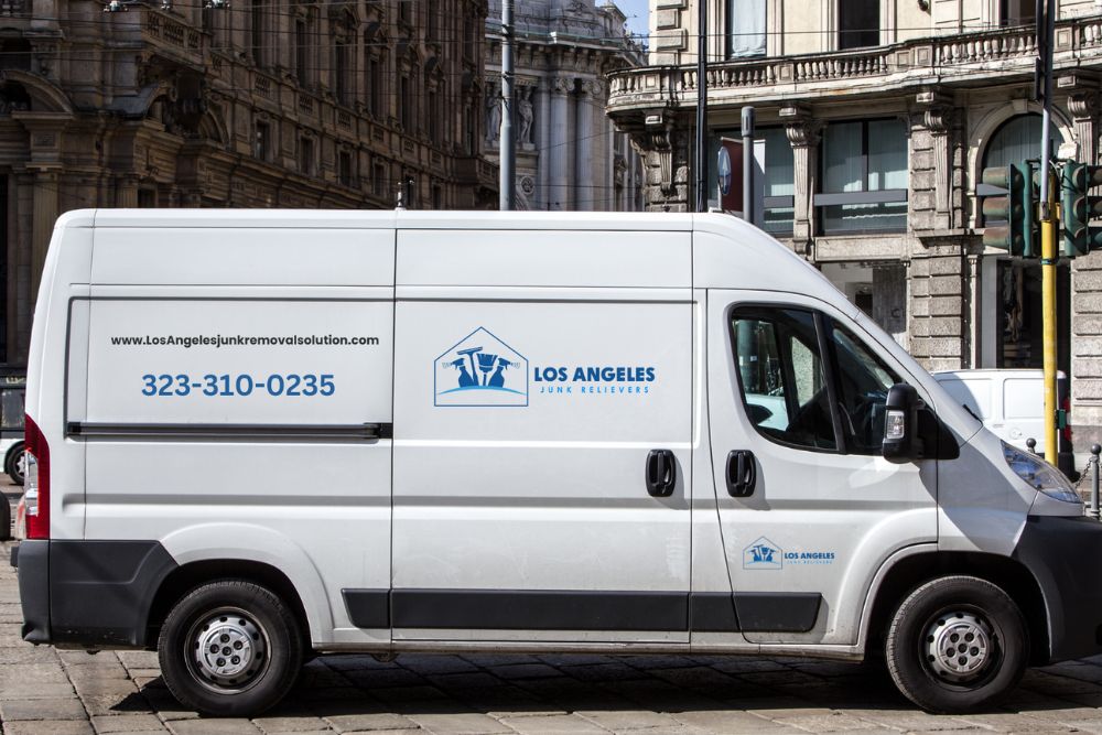 A white van parked on the side of the street, associated with a junk removal service in Los Angeles, CA.