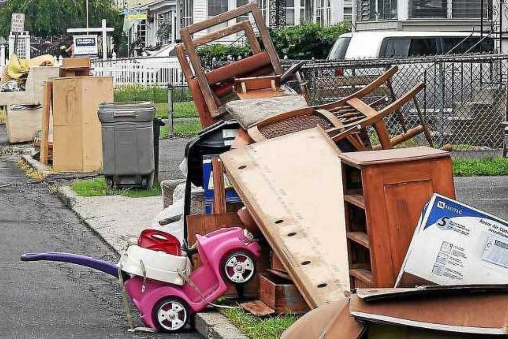 A collection of furniture and toys left on the side of the road, showcasing bulk junk removal services in Los Angeles, CA.