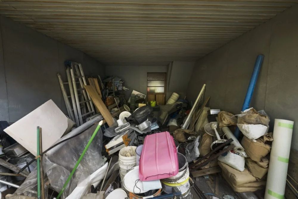 A container filled with a large pile of junk, illustrating an indoor junk removal service in Los Angeles, CA.
